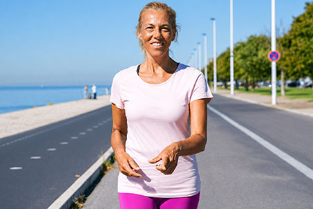 Active woman walking outdoors with improved appetite awareness and healthy lifestyle