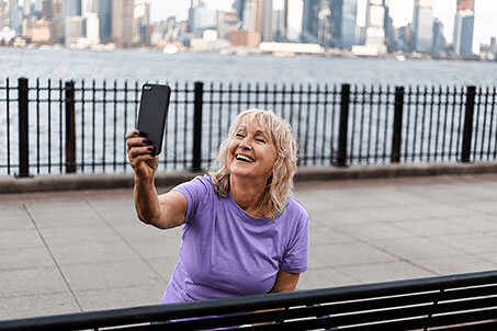 Woman taking a selfie outdoors after successful clinician-guided weight loss journey